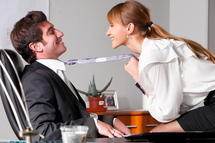Businesswoman is seducing her boss at office