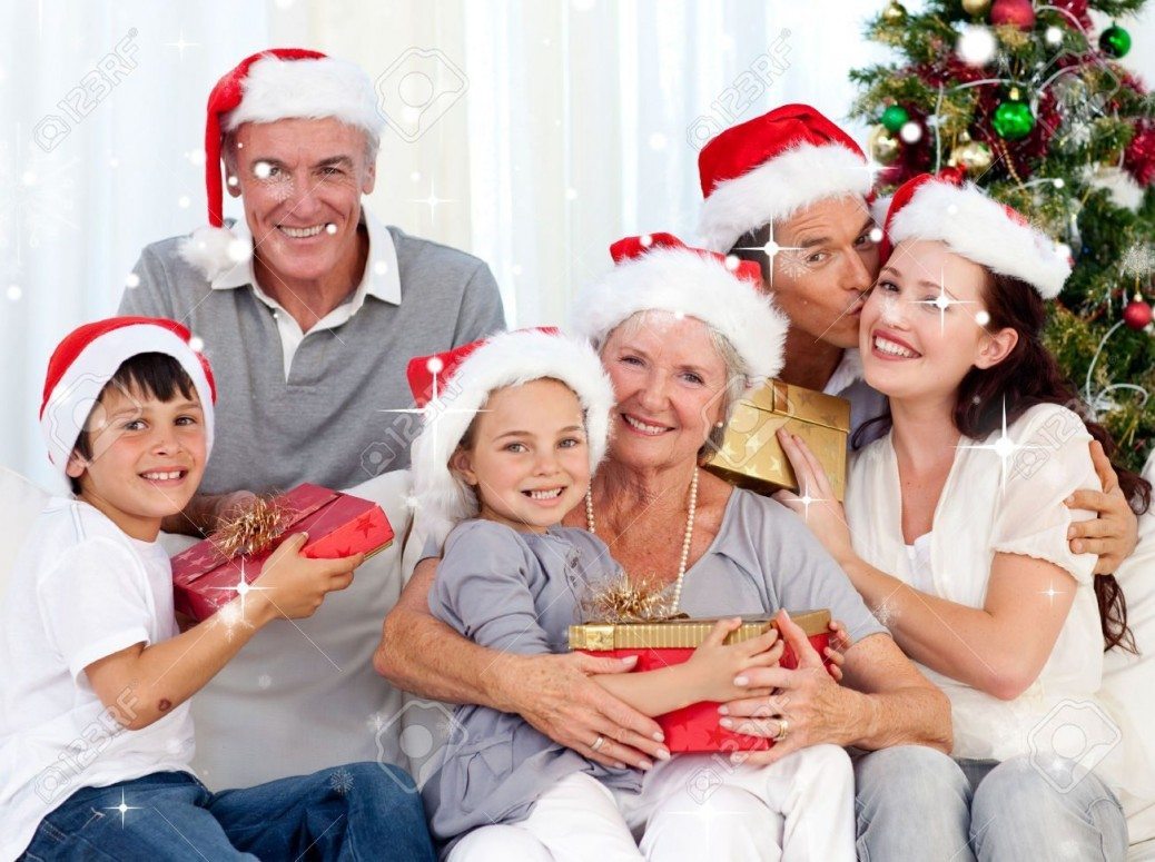 31861871-Smiling-family-at-Christmas-against-snow-falling-Stock-Photo